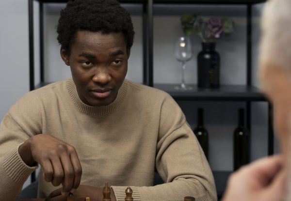 front-view-young-man-playing-chess