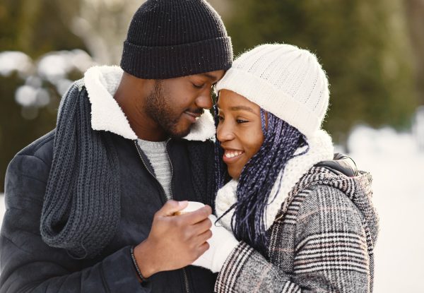 people-walks-outside-winter-day-african-couple-with-coffee